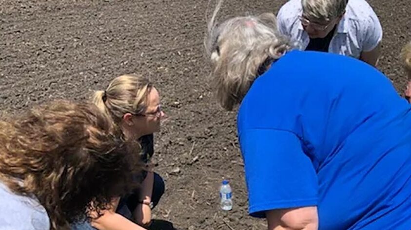 women looking at soil quality