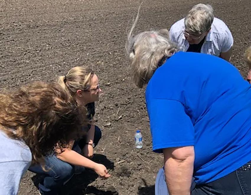 women looking at soil quality