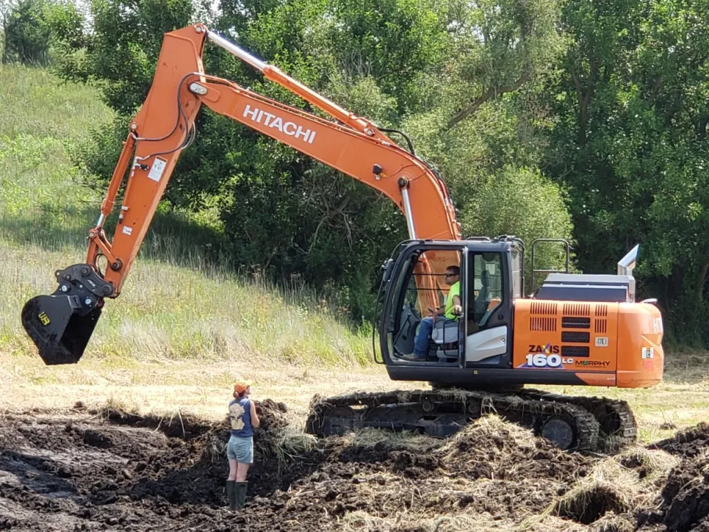 Karen Wilke, Iowa freshwater specialist for The Nature Conservancy, guides oxbow restoration on Camille Rogers’ farm in 2021.