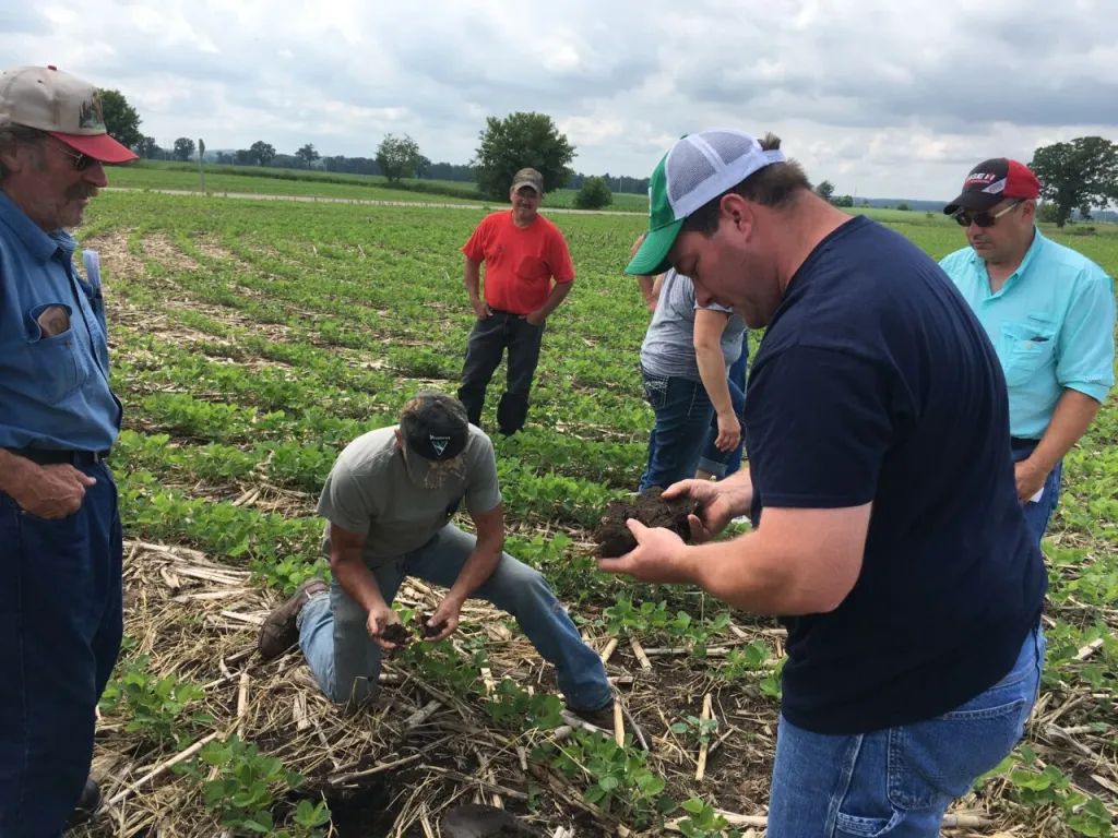 Matt Hintz talks no-till and soil with neighbors.