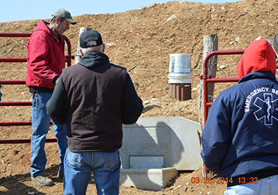 people looking over farm equipment