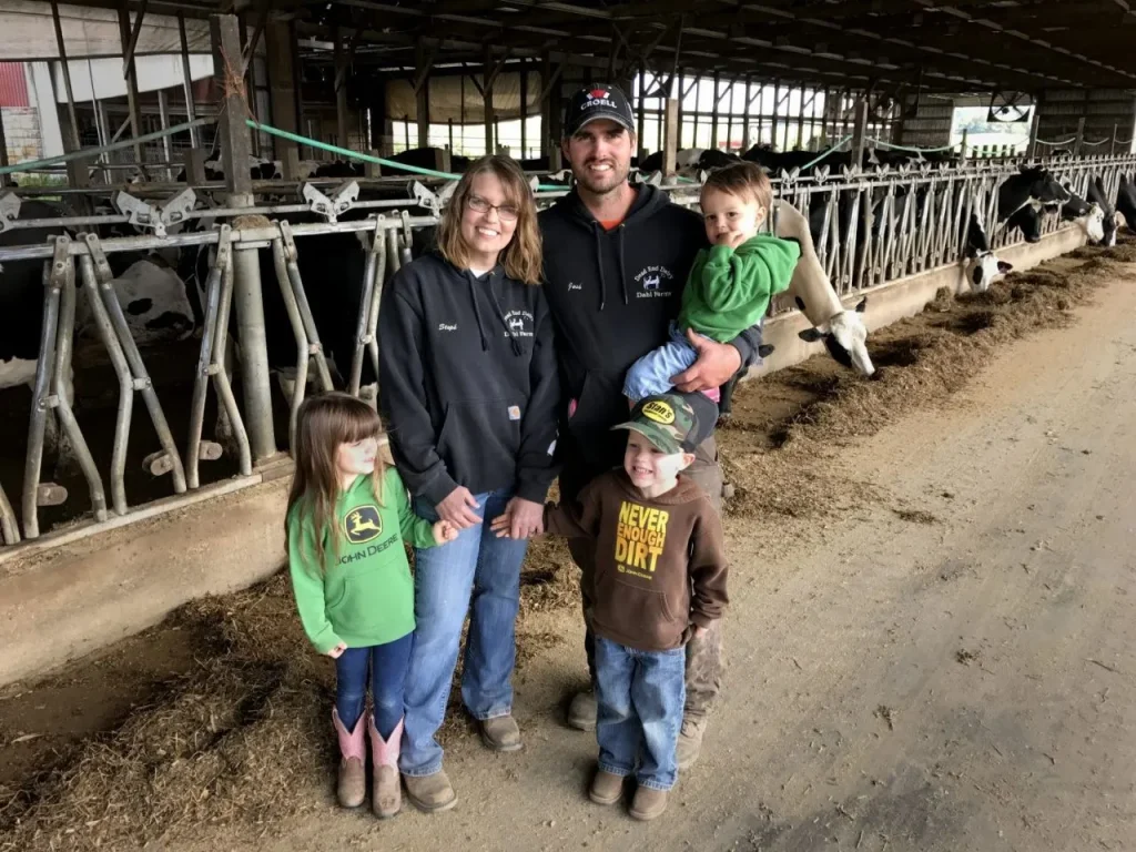 family pictured in barn