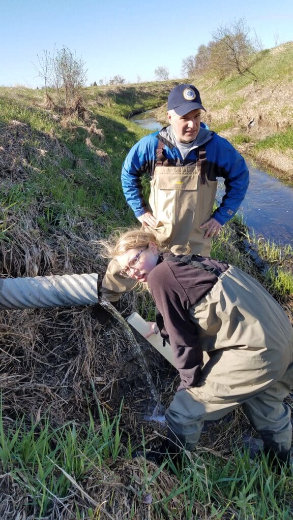 Professor Paul Jackson, St. Olaf College, and student collect drainage samples in Rice Creek Watershed.
