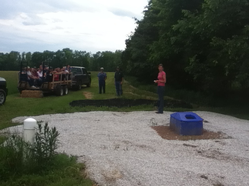 Rachel Hopkins shows neighbors an alternate cattle watering system on her farm.