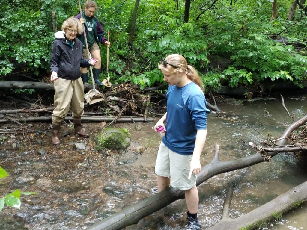 Professor Kathy Shea, St. Olaf College, and students collect macroinvertebrates in Rice Creek.
